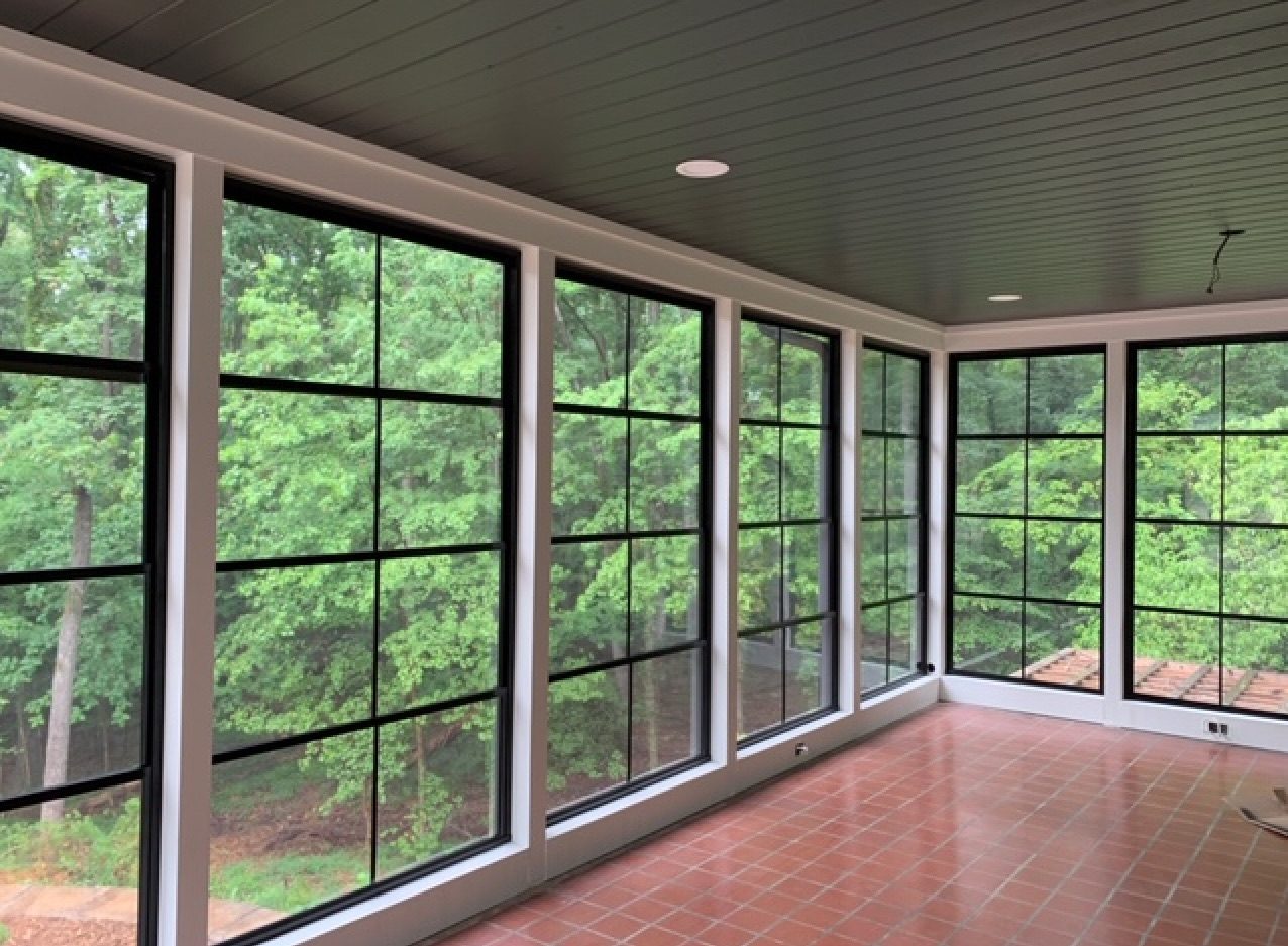 Black-framed screened room with a tile floor