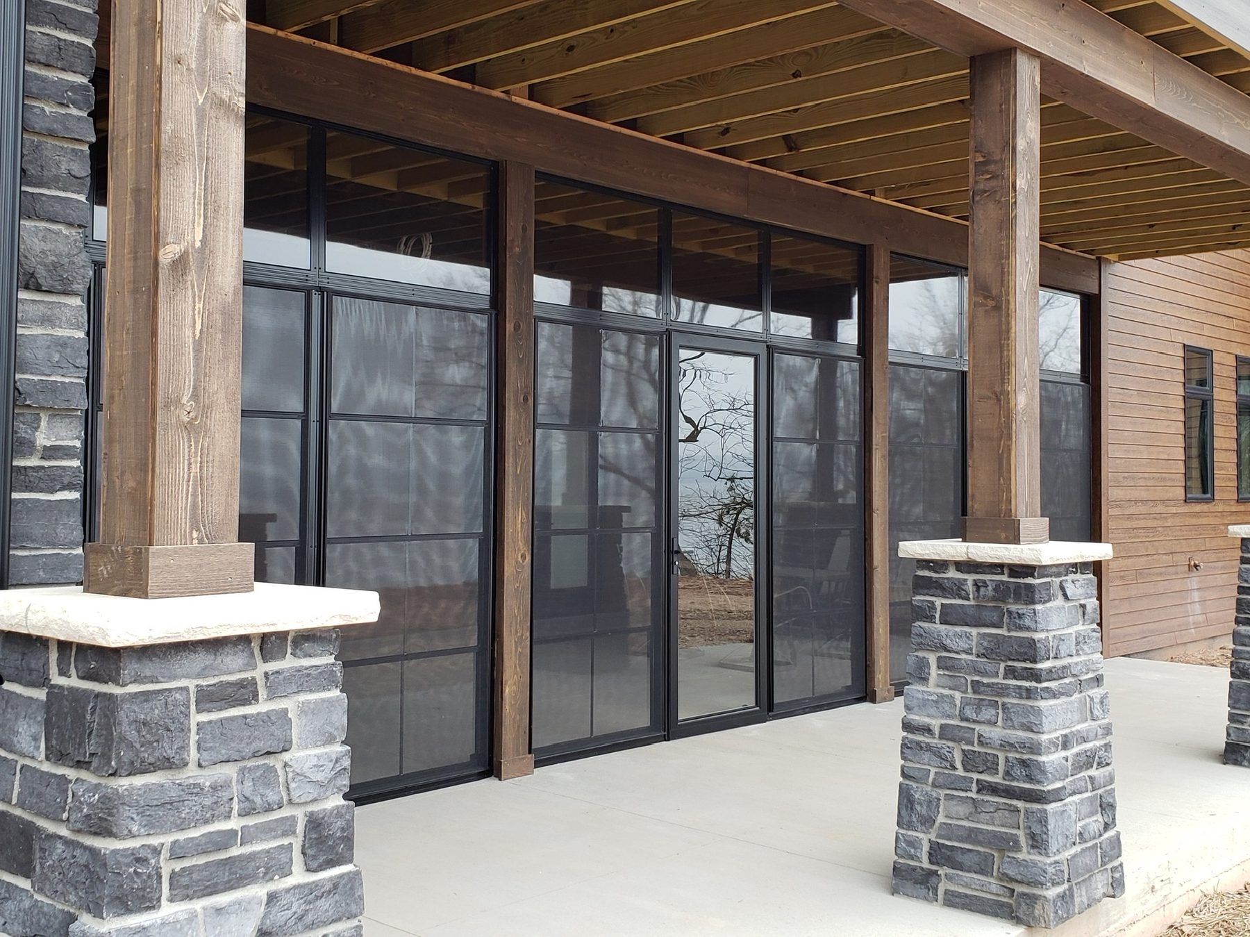 Screened room between stone columns