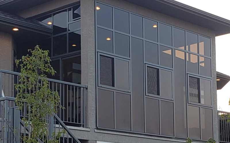 Exterior of a modern two-storey home addition with large windows and a balcony, built by Serene Sunrooms in the Greater Toronto Area