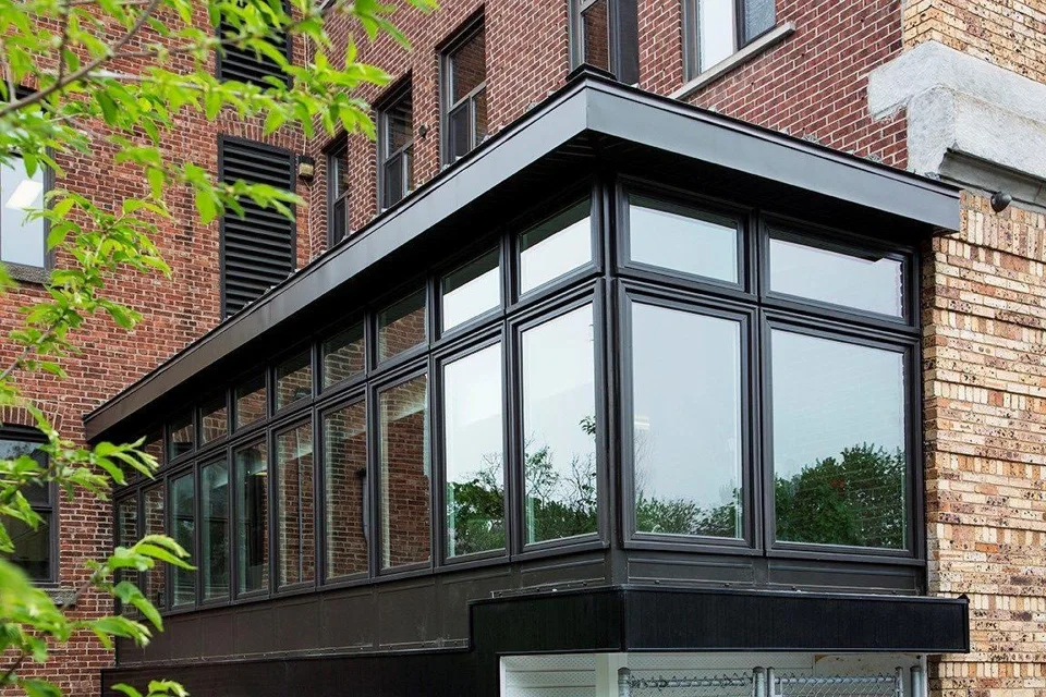 Studio sunroom with a single sloping roof against a modern home