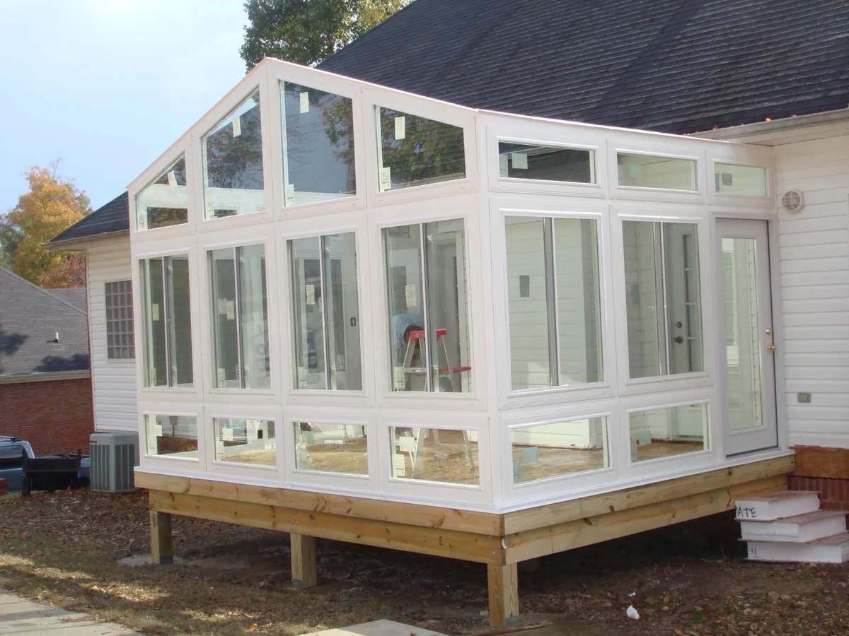 White sunroom frame set on a new timber platform