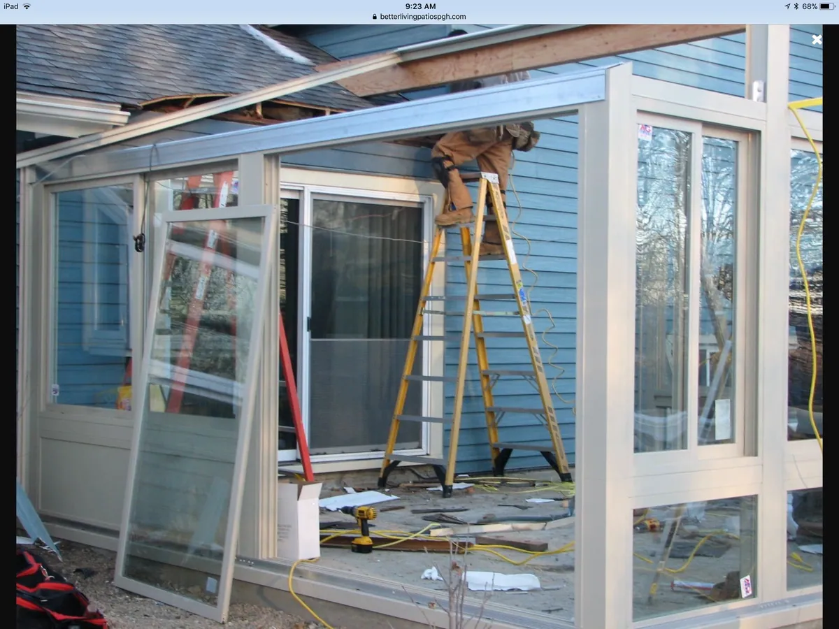 Installer setting glass panels into the frame