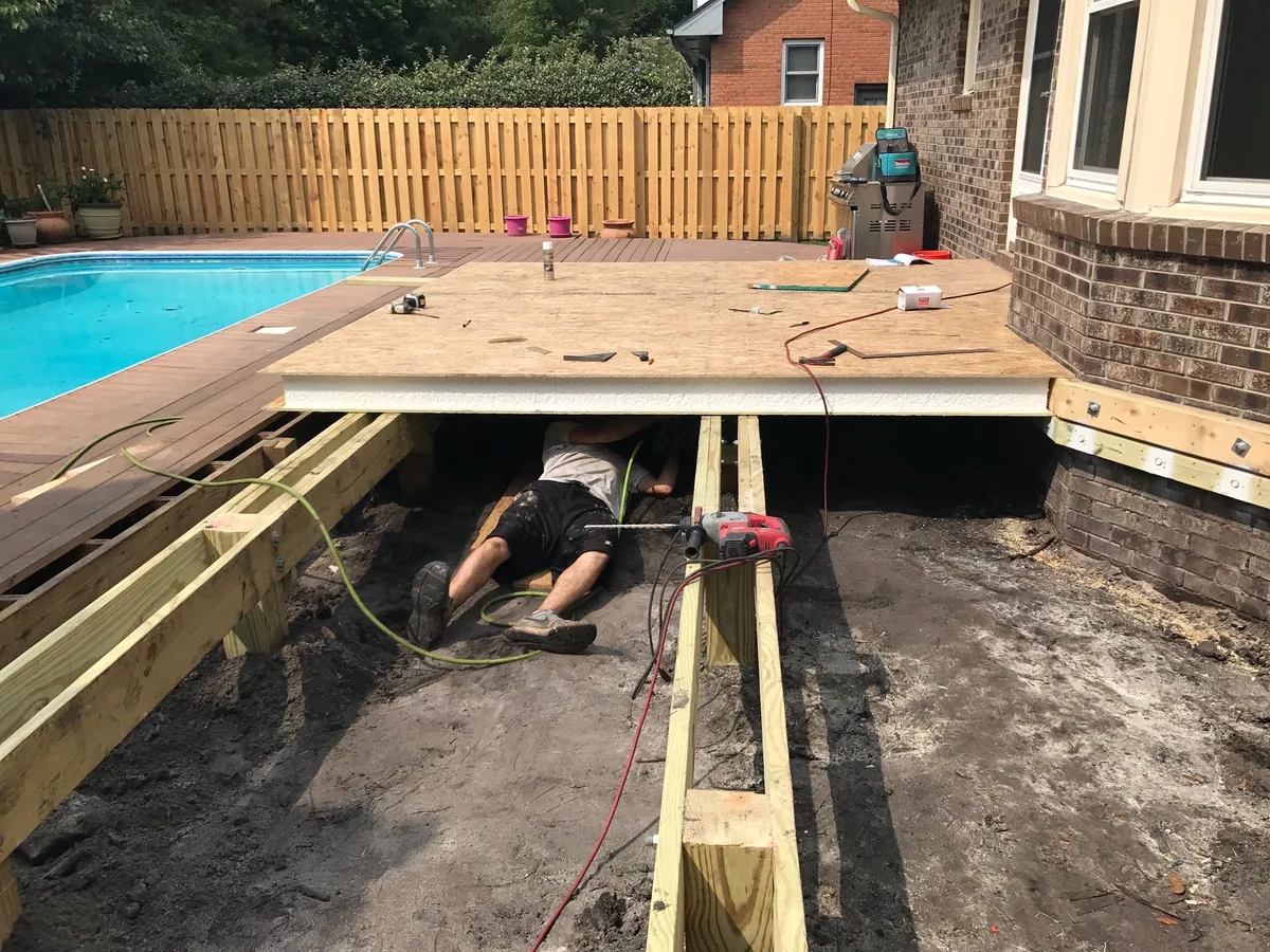 Timber deck floor framing going in beside a pool