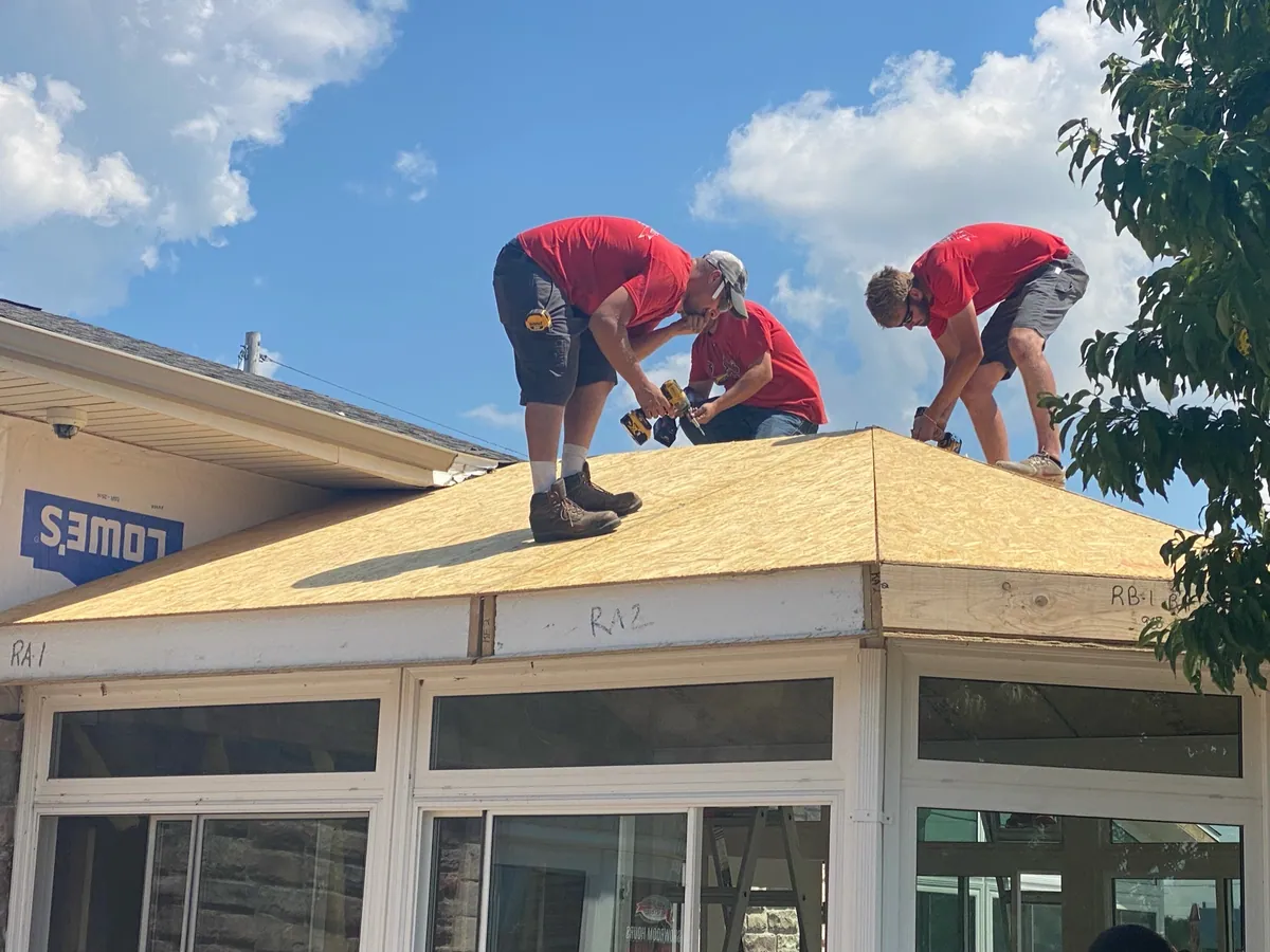 Crew sheathing a hip roof