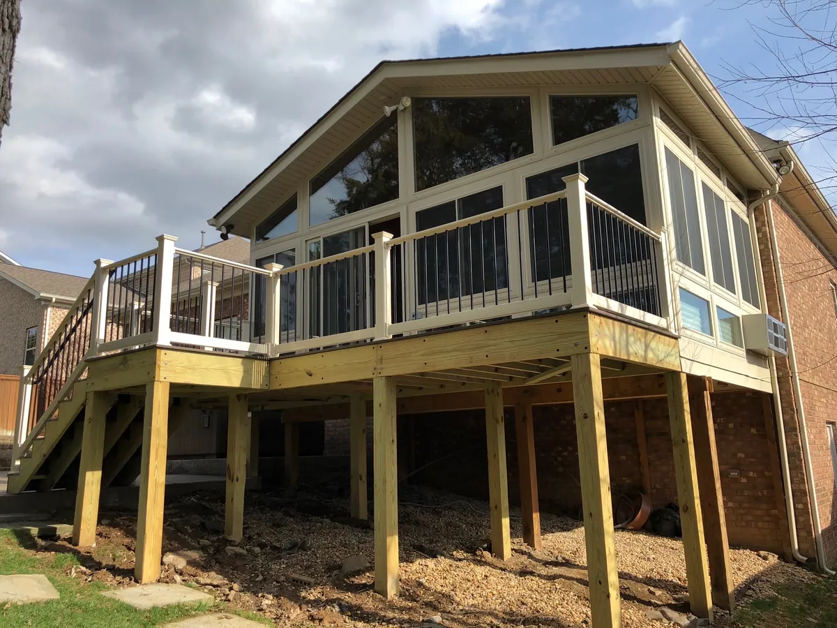 A-frame sunroom on a raised timber deck with stairs