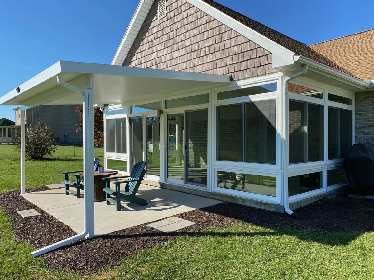 Sunroom with an open aluminum patio cover shading the adjoining patio