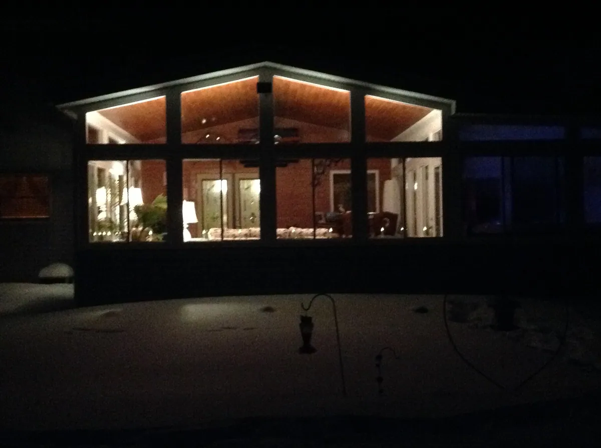 Sunroom glowing from within at night
