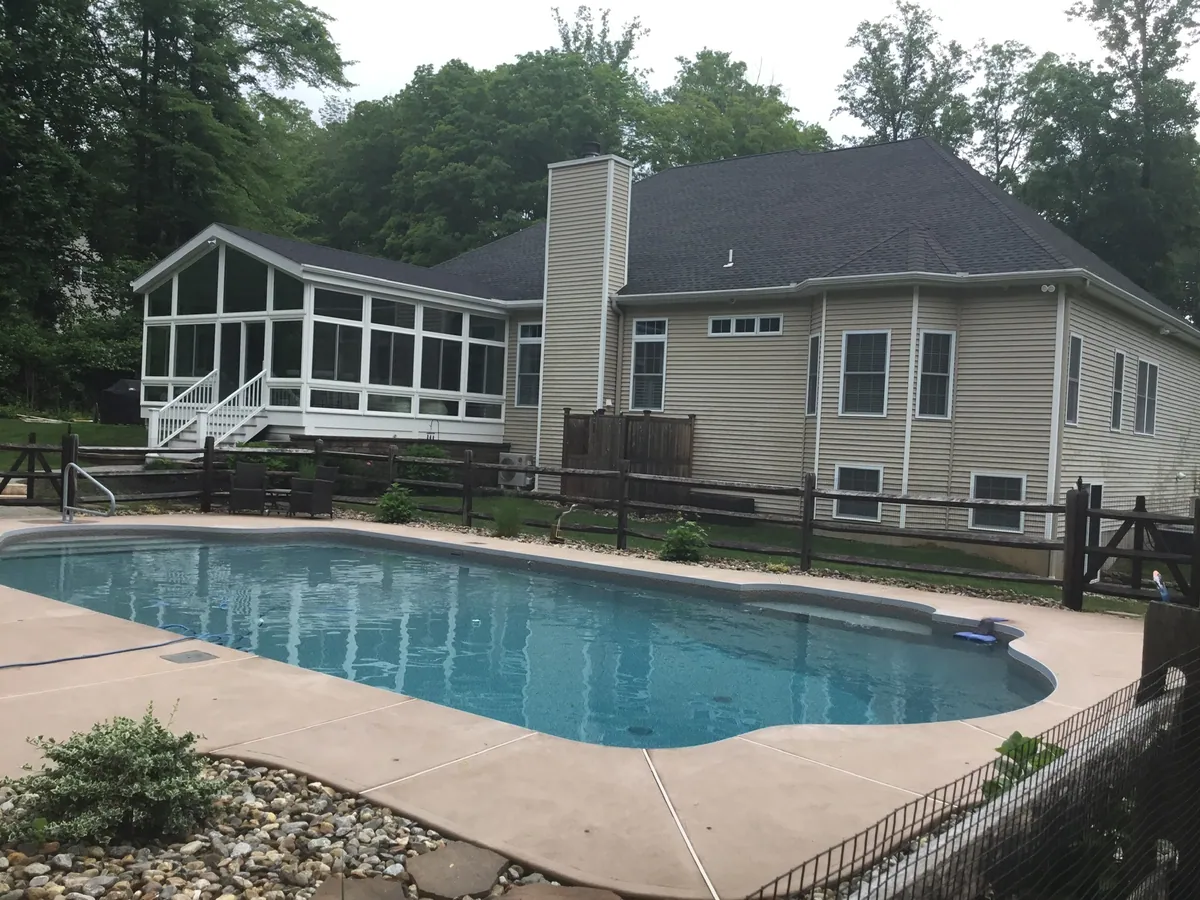 Sunroom overlooking an in-ground pool