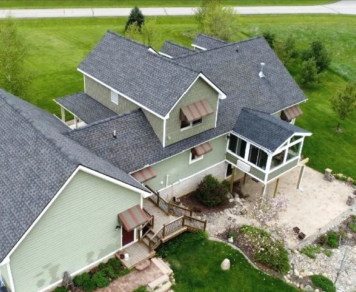 Aerial view of a sunroom tucked into the roofline of a large home