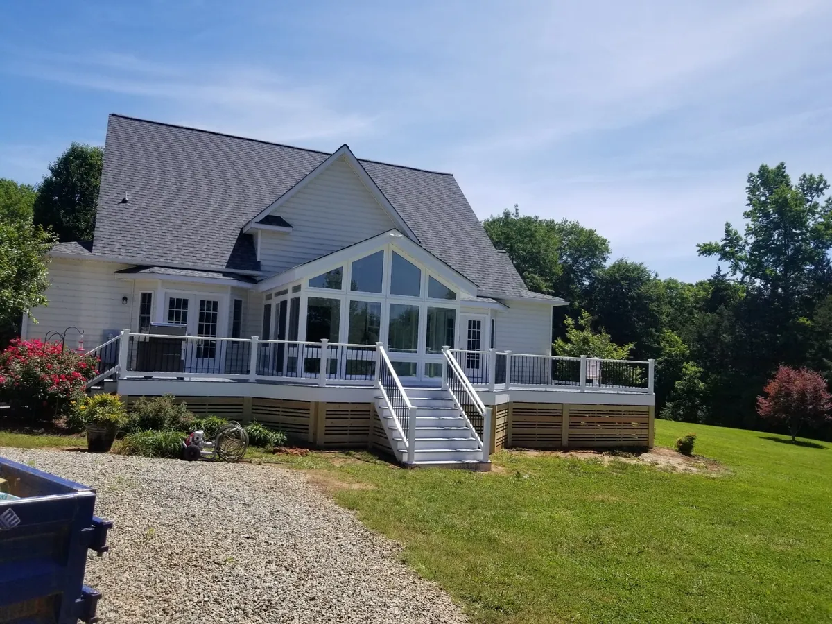 Sunroom on a raised deck with a railed staircase