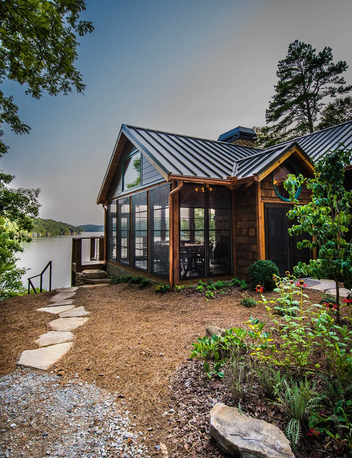 Gable enclosure with a standing-seam metal roof and stone path