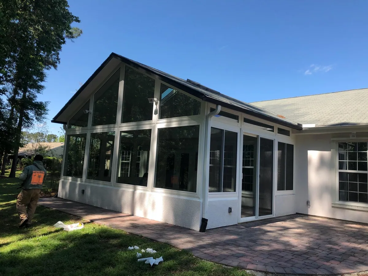 Gable screened room under a clear blue sky