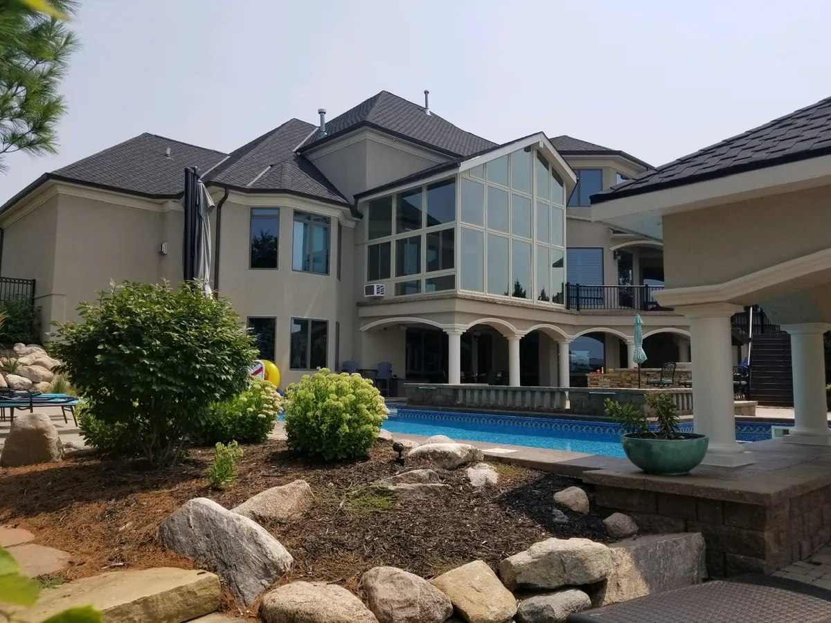 Sunroom above a pool terrace and rock garden