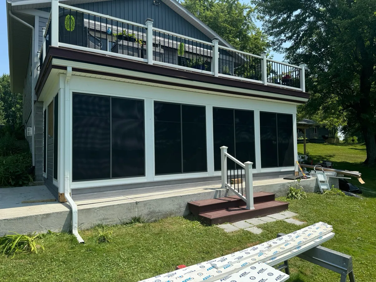 Enclosed room tucked beneath an upper-storey balcony