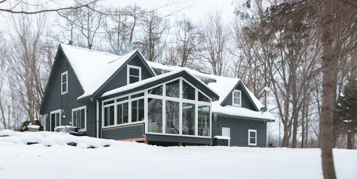 Gable sunroom on a dark-sided home in fresh snow