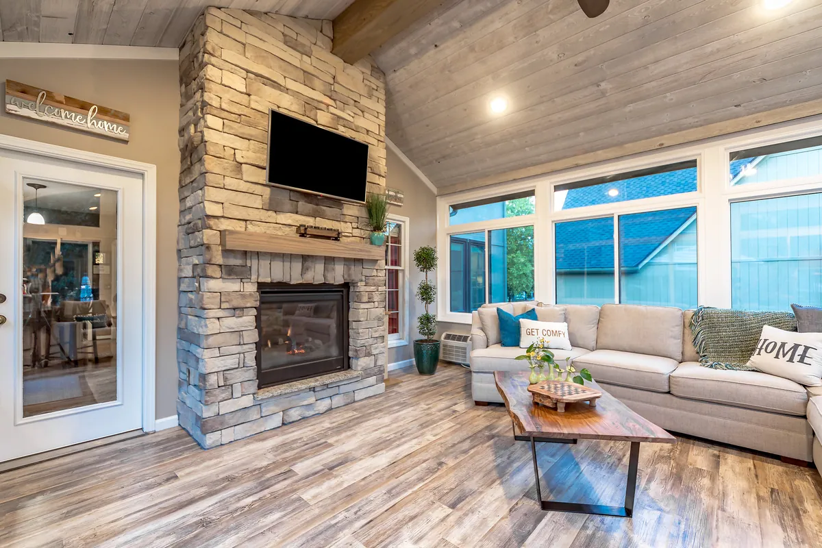 Stone fireplace and television wall under a cathedral ceiling