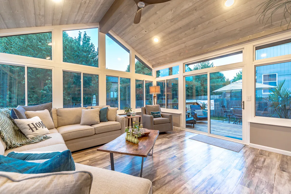 Sunroom living room with a wood cathedral ceiling and sectional sofa