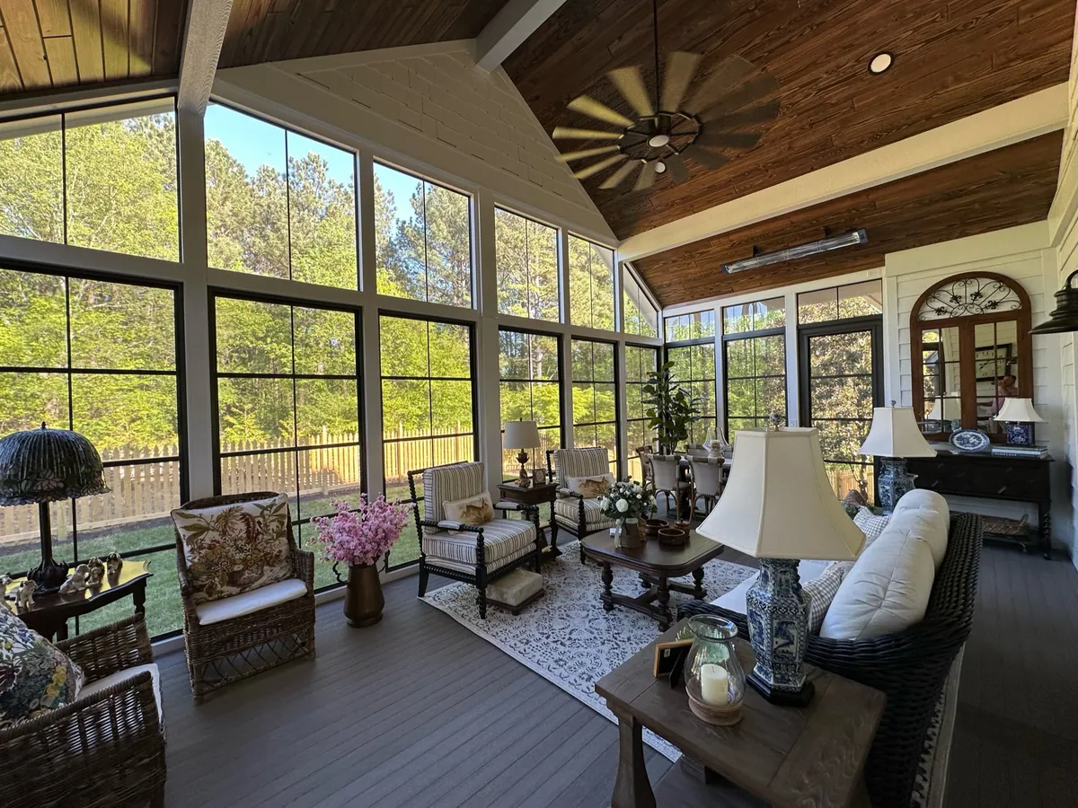 Wood-ceiling sunroom with lamps, fan and lounge seating