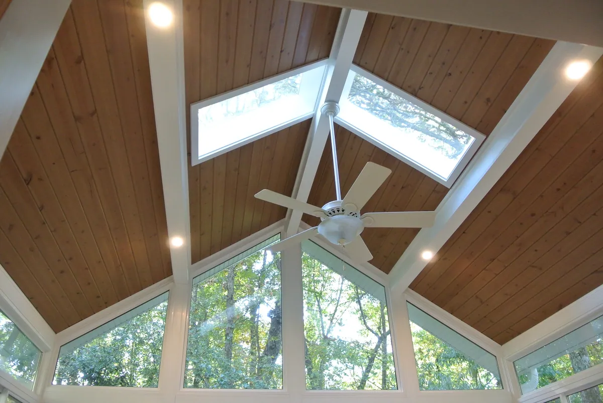Tongue-and-groove cathedral ceiling with skylights and a ceiling fan