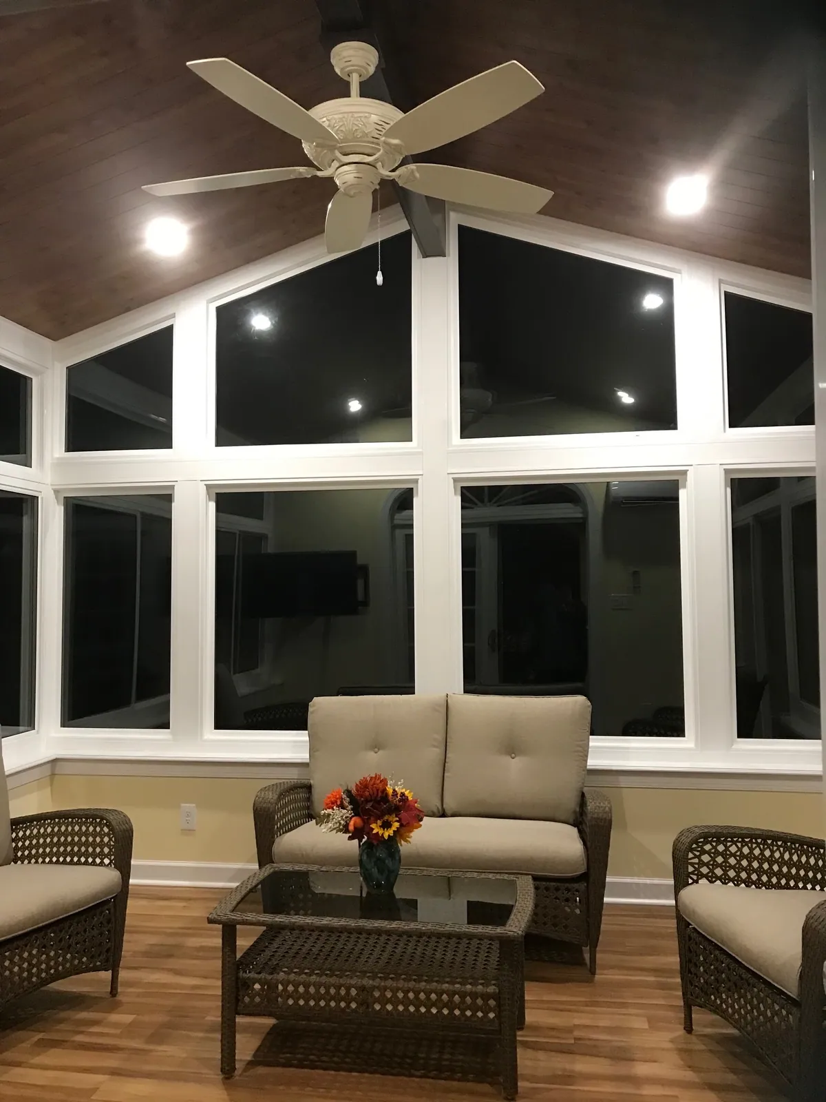 Sunroom lounge under a dark ceiling with recessed lights