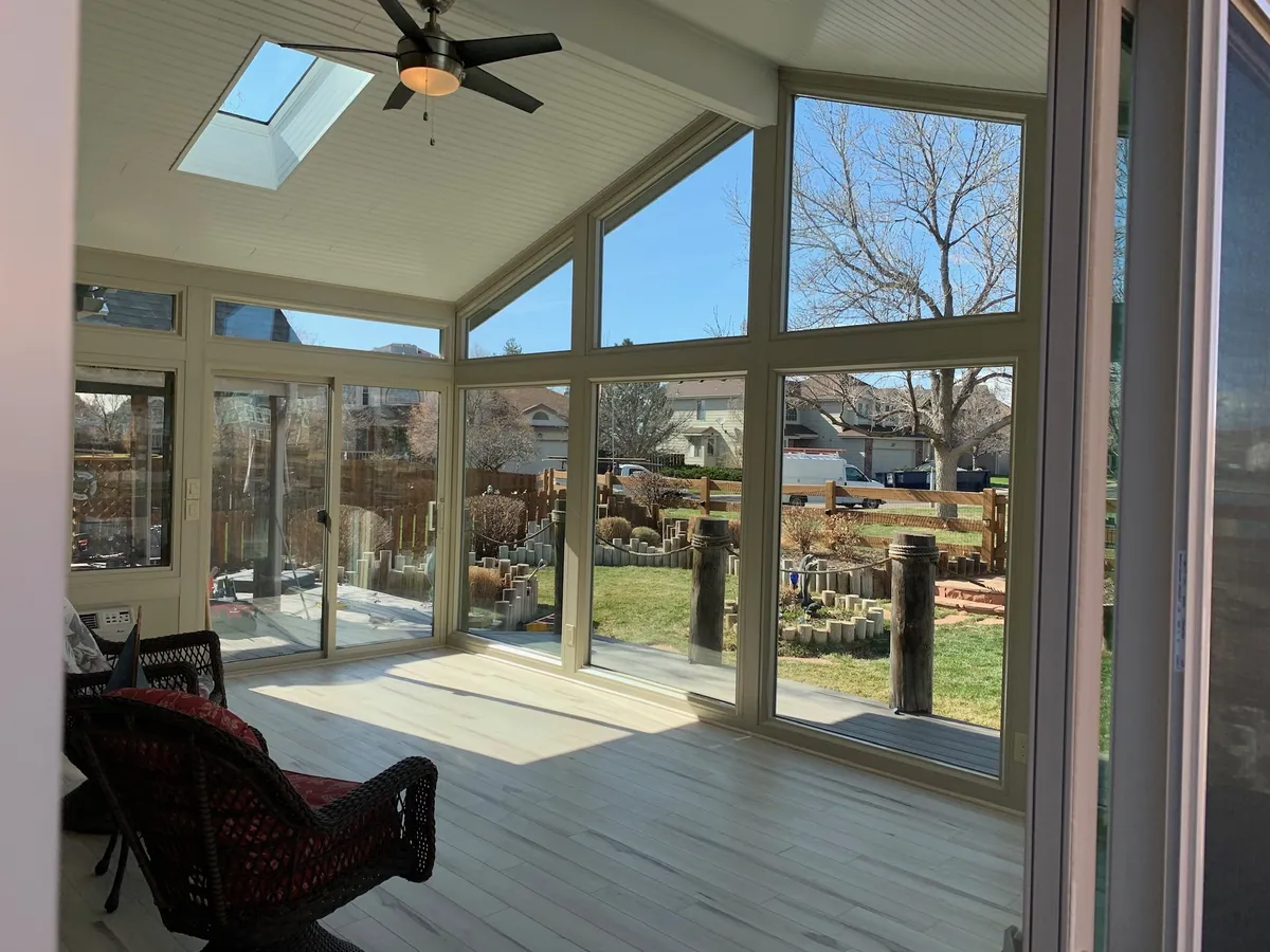 Sunroom with a skylight and reading chair looking over the yard