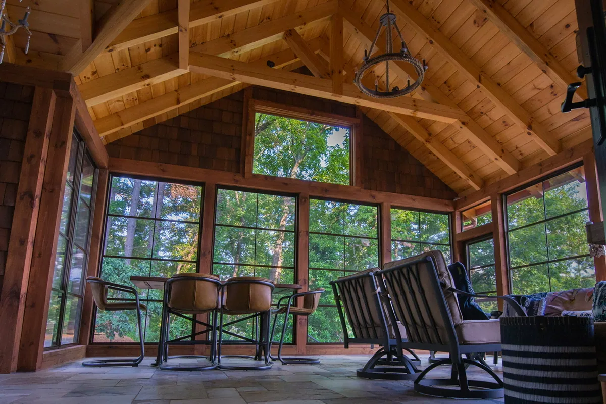 Vaulted timber ceiling over a porch furnished with rocking chairs