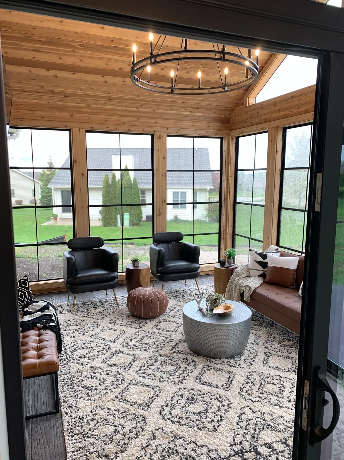 Sunroom with a chandelier and patterned rug