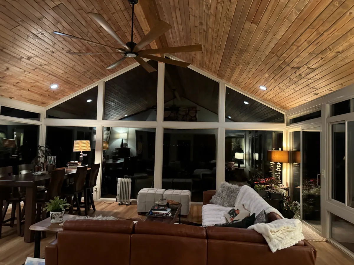 Cedar cathedral ceiling over a leather sofa in the evening