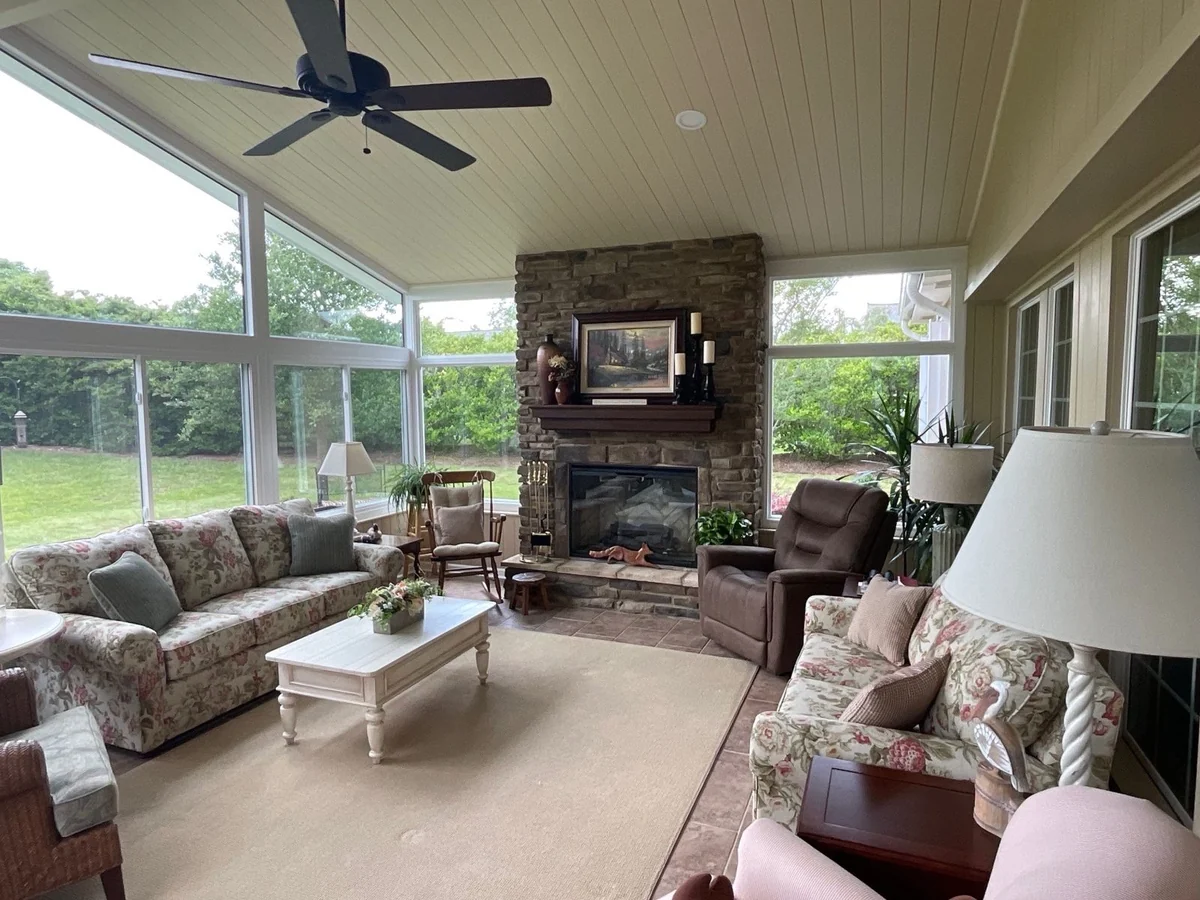 Glass-walled room with a stone fireplace