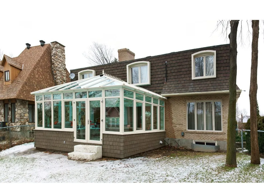 Glass-roof conservatory on a brick home
